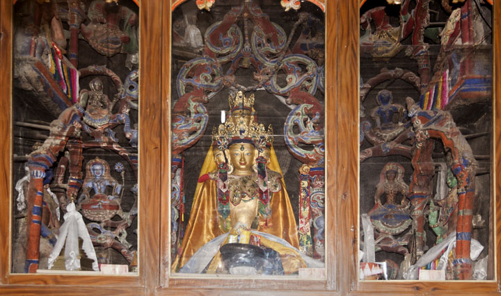 View of Indo-Tibetan clay sculptures of altar, now unfortunately encased by glass making it difficult to see the fine craftsmanship of Kashmiri artists, ca. early 11th century, Mangyu Monastery, Ladakh