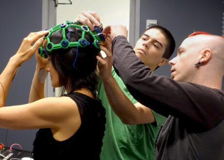 Art-a-Hack Artist Eva Lee getting OpenBCI EEG headgear adjusted
