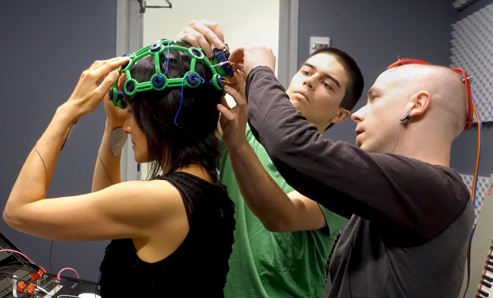 Art-a-Hack Artist Eva Lee getting OpenBCI EEG headgear adjusted